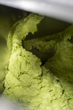 View of fresh guacamole being processed by industrial machinery in an avocado factory in Uruapan, Michoacan, Mexico.