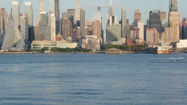 New York City Manhattan Midtown skyline, Hells kitchen from New Jersey, Weehawken Port Imperial, United States. Urban cityscape with skyscraper building, American architecture. Hudson River waterfront