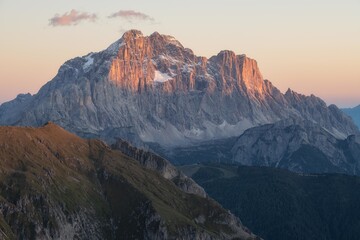 Factual high alpine peak with orange alpenglow lighting in the Dolomites, Italy. Useful for travel, nature, and adventure themes. © marcodenaro
