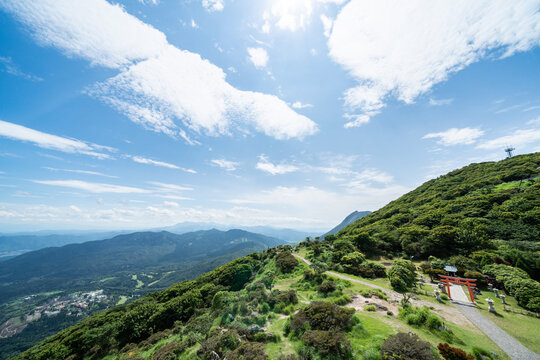 Panoramic aerial view of Beppu city and Beppu bay under blue sky with clouds from mountain viewpoint in Oita Japan