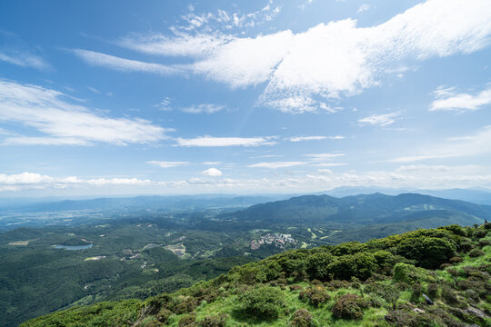 Panoramic aerial view of Beppu city and Beppu bay under blue sky with clouds from mountain viewpoint in Oita Japan