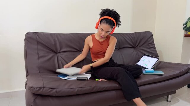 Young woman starting a video call on a laptop at home