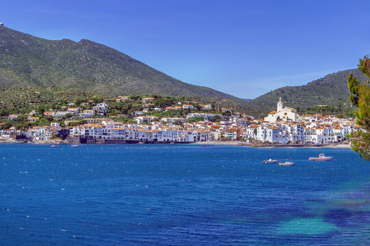 View of Cadaques town from the sea, Catalonia, Spain. Coastal panorama, sunny day, Mediterranean architecture