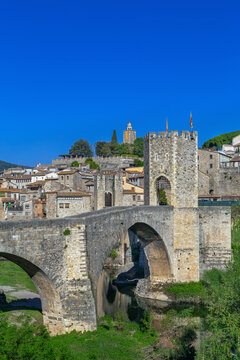 Romanesque bridge of Besalu in Catalonia Spain, vertical view. Sunny daylight, medieval stone architecture