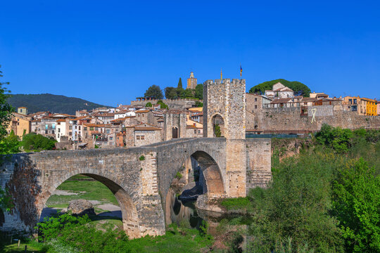 Romanesque medieval bridge in Besalu, Catalonia, Spain, close up view. Sunny daylight, historic stone architecture