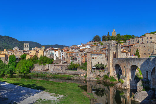 View of historic town from the medieval bridge, Besalu, Catalonia, Spain. Daytime scenery, traditional architecture