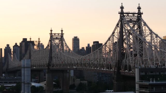 New York City Manhattan Midtown skyline from Queens, Queensboro bridge architecture, United States. Cityscape from rooftop in Long Island, Hunters Point. Urban sunset over transport metallic bridge.