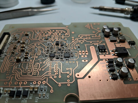 Close up of electronic circuit board with copper traces and soldered components