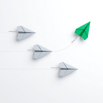 A single vibrant green paper plane soaring in a different direction than the group of grey ones symbolizing unique leadership and innovative thinking