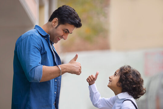 Little school boy promising his father for not doing any wrong work