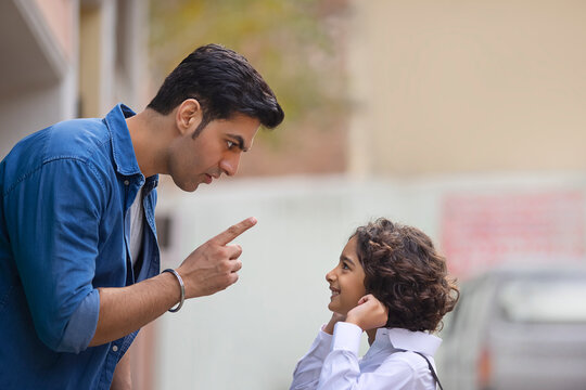 Little school boy apologizing to his father for the mistake