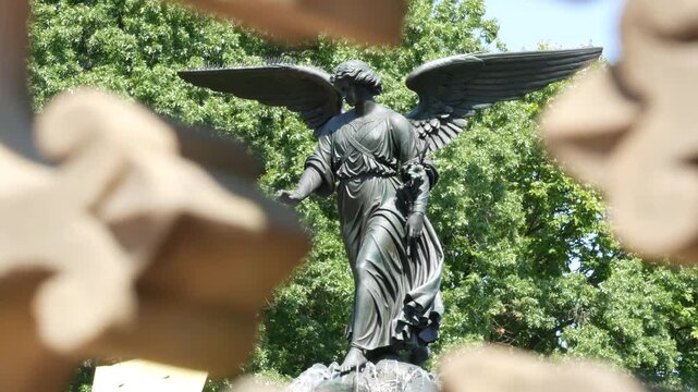 New York City Central Park Bethesda Fountain, angel statue by Bethesda Terrace on summer day, United States. Greenery and sculpture in morning. Autumn fall leaves and green trees in NYC Manhattan, USA