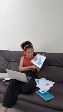 Young businesswoman presenting charts during online video conference