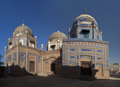 View of the historic Abbasi Royal Graveyard featuring intricate blue tile work and traditional domes in Derawar, Punjab, Pakistan.