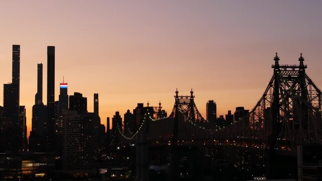 New York City Manhattan Midtown skyline from Queens, Queensboro bridge architecture, United States. Rooftop cityscape from Long Island Hunters Point. Urban sunset twilight dusk dark evening silhouette