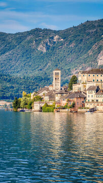 Panoramic view of San Giulio Island on Lake Orta, Piedmont, Italy, featuring the historic basilica and picturesque lakeside scenery surrounded by Alpine landscapes
