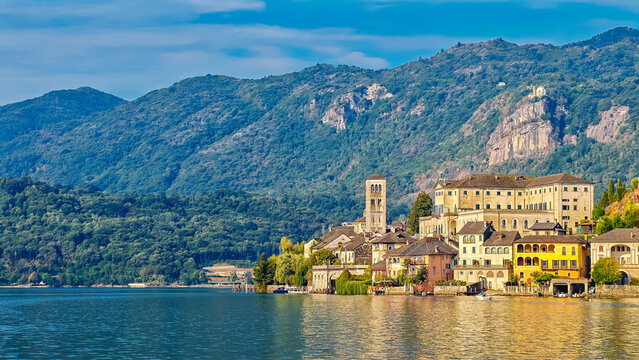 Panoramic view of San Giulio Island on Lake Orta, Piedmont, Italy, featuring the historic basilica and picturesque lakeside scenery surrounded by Alpine landscapes