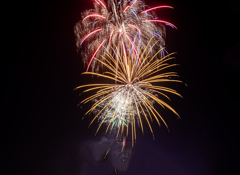 View of colorful fireworks illuminating the night sky above the Minar-e-Pakistan monument in Lahore, Punjab, Pakistan.