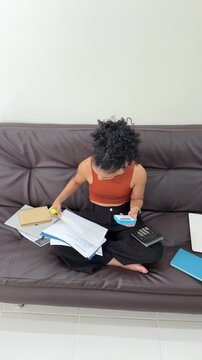 Young woman managing finances at home