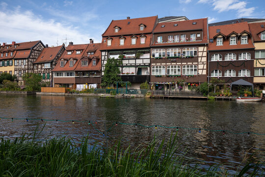 20 August 2026, View of historic waterfront houses along the Regnitz river during the 76th Sandkirchweih festival in Bamberg, Bavaria, Germany.