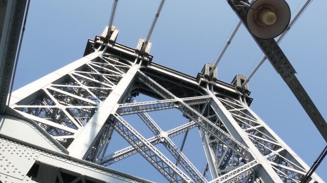 Williamsburg Bridge from Manhattan to Brooklyn, New York City, USA. Architecture of United States, tourist landmark. Metallic cable-stayed bridge. Cables and sky from pedestrian path. Low angle.