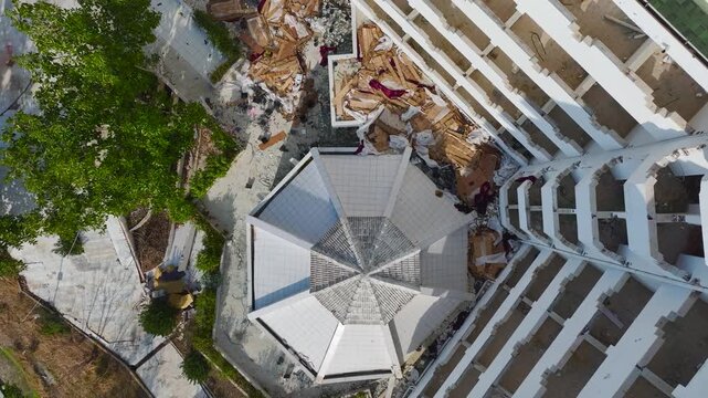 Aerial Video of Large Abandoned Resort Hotel with White Walls and Empty Pool Located on the Coastline