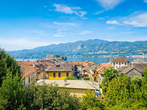 Panoramic view of Orta San Giulio on the shores of Lake Orta, Piedmont, Italy. Aerial drone view showcasing the historic lakeside town