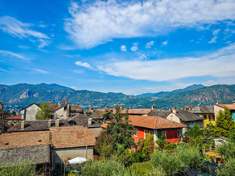 Panoramic view of Orta San Giulio on the shores of Lake Orta, Piedmont, Italy. Aerial drone view showcasing the historic lakeside town