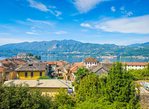 Panoramic view of Orta San Giulio on the shores of Lake Orta, Piedmont, Italy. Aerial drone view showcasing the historic lakeside town