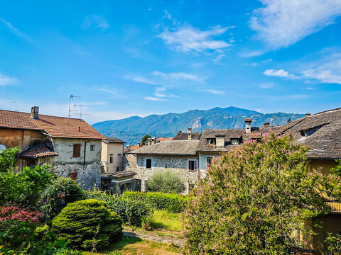 Panoramic view of Orta San Giulio on the shores of Lake Orta, Piedmont, Italy. Aerial drone view showcasing the historic lakeside town