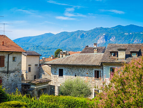 Panoramic view of Orta San Giulio on the shores of Lake Orta, Piedmont, Italy. Aerial drone view showcasing the historic lakeside town