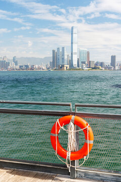 Hong Kong skyscraper panorama on a sunny day with water and boats