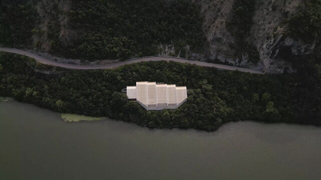 Aerial drone footage of the modern glass protective structure and visitor center at Lepenski Vir archaeological site in Iron Gate National Park, Serbia. 20.07.2026