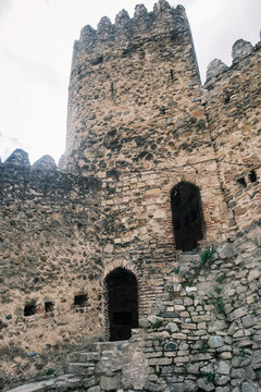 View of the historic Ananuri Fortress Complex featuring weathered stone walls and arched doorways in Ananuri, Mtskheta-Mtianeti, Georgia.