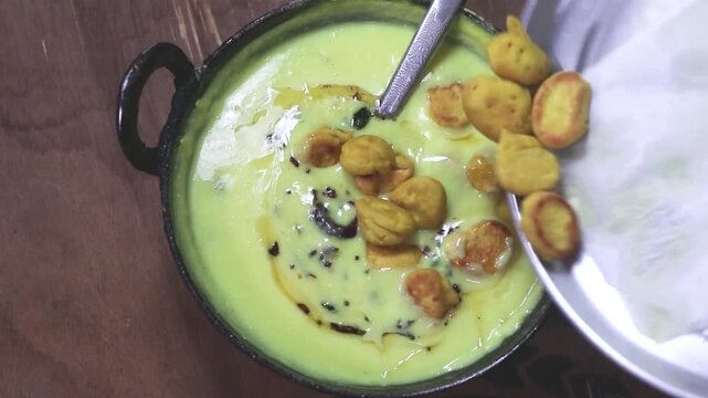A bowl of warm kadhi an indian recipe  getting tempered