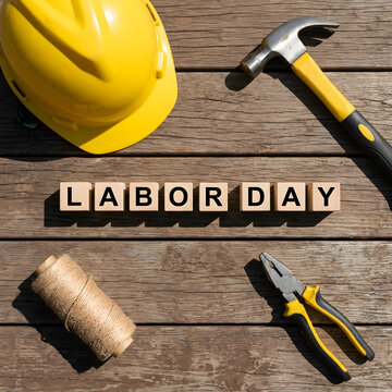 Labor Day Construction Concept with Wooden Blocks and Yellow Hard Hat Outdoors