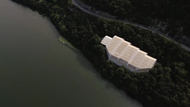 Aerial drone footage of the modern glass protective structure and visitor center at Lepenski Vir archaeological site in Iron Gate National Park, Serbia. 20.07.2026