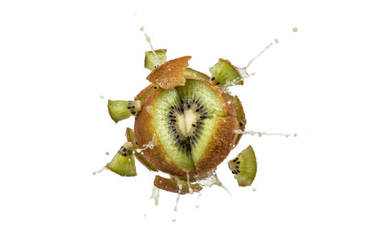 Fresh green kiwi fruit exploding with water splashes and flying slices isolated on a transparent background