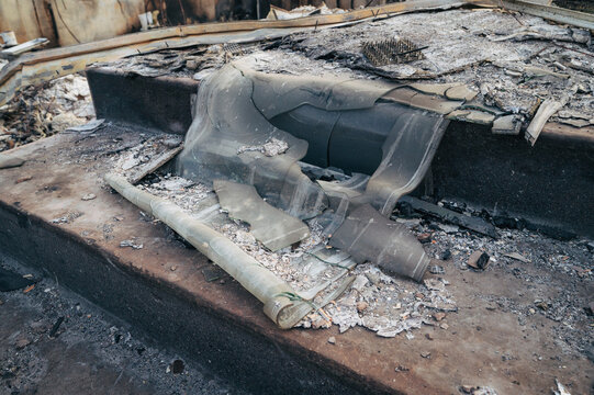 View of fire-damaged debris and melted glass on a concrete surface in Spokane, Washington, United States.