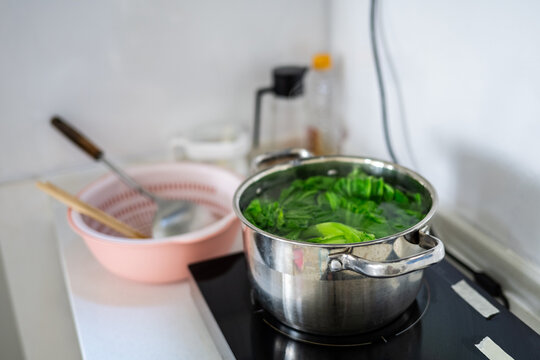 Mustard greens blanching in the pot
