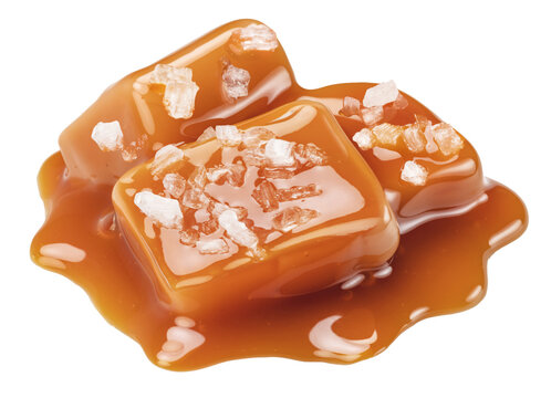 Salted caramel candies topped with sea salt crystals and liquid caramel drizzle for gourmet confectionery, with clipping path.