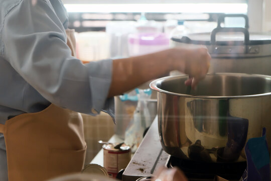 Close up Image of Woman preparing food at the stove