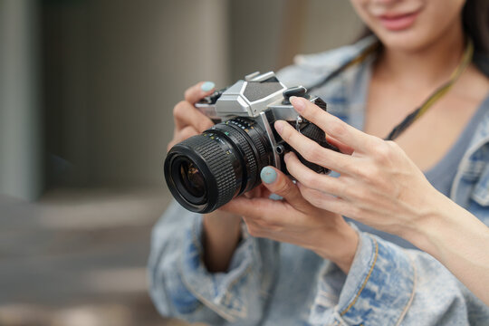 Asian woman holding vintage camera outdoors for travel vacation lifestyle