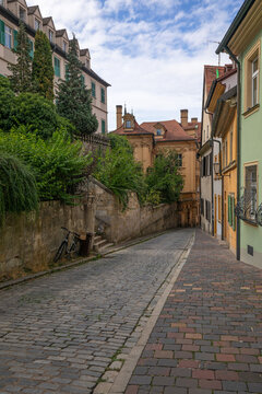 20 August 2026, A bicycle stands on a cobblestone street lined with historic buildings in Bamberg, Bavaria, Germany.