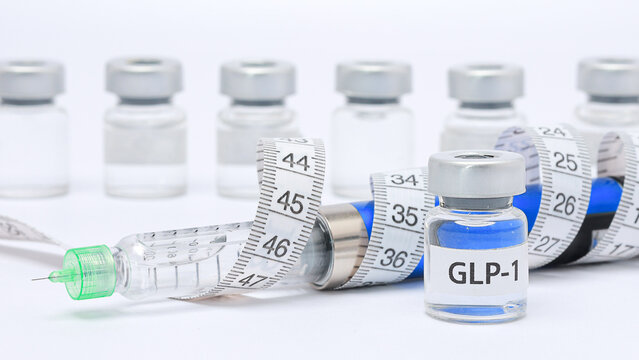 Medical GLP1 vial and syringe with tape measure on white background evoke hopeful feeling of health loss weight management concept