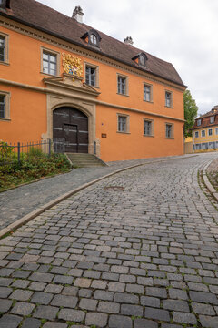 20 August 2026, Exterior view of the historic Haus zur Goldenen Wappe along a cobbled street in Bamberg, Bavaria, Germany.
