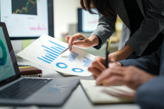Business Team Analyzing Financial Charts in Office
