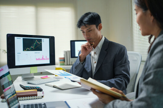 Business Team Analyzing Financial Charts in Office