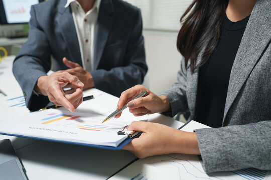 Business Team Reviewing Financial Charts in Office