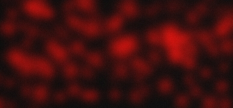 Blurred red spots against a dark background